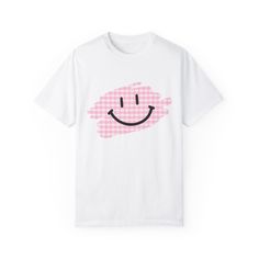 Comfort Colors Smiley Face Plaid T-Shirt | Cute and Cozy Design Stay comfy and cute with this fun Comfort Colors 1717 t-shirt featuring an adorable smiley face peeking out from a trendy plaid design! Crafted from ultra-soft, vintage-washed cotton, this tee is perfect for anyone who loves laid-back style with a playful twist. The unique blend of classic plaid and a happy, smiling face brings a little extra joy to your everyday wardrobe. Features: -Comfort Colors 1717 Tee: Made from 100% ring-spun cotton for that lived-in softness from day one. -Playful Design: The cute smiley face peeking out from a plaid pattern adds charm and personality to your outfit. -Relaxed Fit: Ideal for casual, everyday wear with its relaxed and comfortable silhouette. -Versatile Style: Dress it up with your favori Playful White T-shirt With Smiley Face, Fun Cotton T-shirt With Smiley Face, Casual Plaid Cotton T-shirt, Cute Plaid Short Sleeve Tops, Cute Short Sleeve Plaid Tops, Cotton Smiley Face Graphic Tee, Cute Cotton Tops With Smiley Face, Cute White T-shirt With Smiley Face, Casual Cotton Tops With Smiley Face