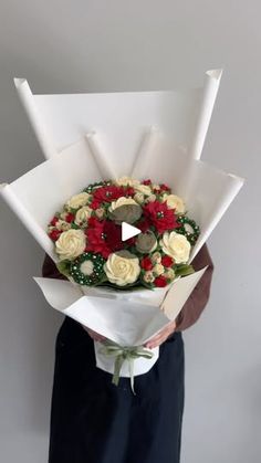 a man holding a bouquet of flowers in his hands