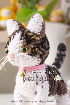 a crocheted cat sitting on top of a table