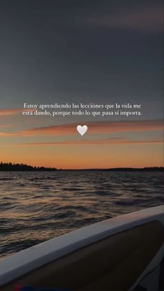 a boat in the water at sunset with a quote about love on it's side