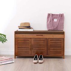 a pair of shoes sitting on top of a wooden cabinet