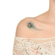 a woman with a peacock feather tattoo on her shoulder