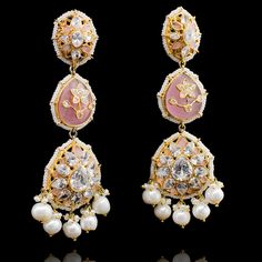 Pull of an ethnic look with a dash of modernity in these stunning earrings! Beautiful, stand-out statement earrings in a mesmerizing design decked out in CZ stones and accented with feroza or pink stones and white pearls. Approximate earrings length is 4". Gold-plated on high-quality brass as base metal. Malika Earring Elegant Pink Chandelier Earrings, Jeweled Kundan Earrings For Reception, Bollywood Style Jeweled Earrings For Reception, Elegant Pink Earrings For Reception, Elegant Pink Bridal Earrings For Reception, Elegant Pink Earrings With Stone Work, Pink Jeweled Wedding Earrings, Pink Kundan Earrings For Reception, Pink Pearl Drop Chandbali Jewelry