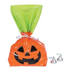 an orange bag with a jack - o'- lantern face on it and candy