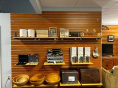 the shelves are full of books and other items on display in an office space with wood paneling