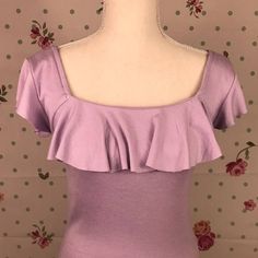 Free People Lavender Top In A Ribbed Material With Large Open Neck With Ruffle Detail. Top Can Be Worn Of The Shoulders. Size Medium. New Without Tags. Approximate Measurements (Laying Flat): Bust 13.25 Inches, Shoulder Seam To Shoulder Seam 17 Inches, Length 23 Inches Chic Lavender Top With Ruffles, Chic Lavender Tops With Ruffles, Chic Lavender Ruffled Top, Feminine Lavender Tops With Ruffles, Feminine Lavender Ruffled Tops, Lavender Ruffled Top For Summer, Purple Stretch Feminine Top, Feminine Fitted Lavender Top, Stretch Purple Feminine Tops