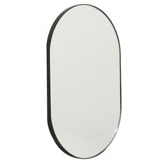 an oval shaped mirror with black trim on a white background, viewed from the side