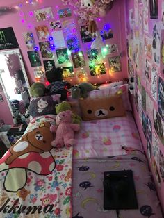 a bedroom with pink walls and lots of stuffed animals sitting on the bed in front of it