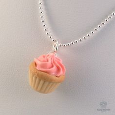 Make someone's birthday a sweet occasion and give this Scented Birthday Cupcake Necklace as a present. This food jewelry features a ¾-inch polymer clay pendant shaped like a vanilla cupcake topped with a dollop of pretty petal pink icing. Fragrance oils give the charm a mouthwatering strawberry cupcake fragrance that is sure to tantalize. Formed entirely by hand, the pendant comes on an 18-inch silver ball chain and has a silver hoop that holds it in place. The cupcake necklace is secured by a s Cupcake Necklace, Food Necklace, 50th Birthday Gifts For Woman, Pretty Jewelry Necklaces, Birthday Gift For Women, Mothers Day Gifts From Daughter, Jewelry Flower, Birthday Cupcake, Pink Cupcakes