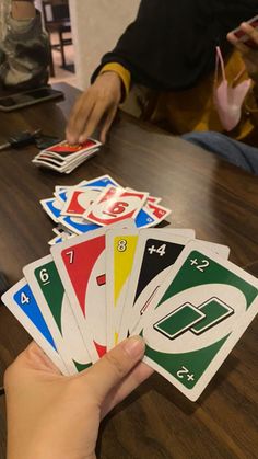 a person is playing cards on a table