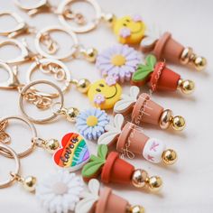 the key chains are decorated with flowers and embellishments, such as smiley faces