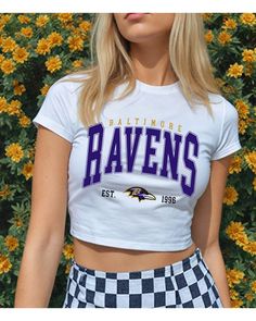 Get ready to cheer on the Baltimore Ravens in style! This shirt is perfect for game days, casual outings, or any day you want to support your favorite team.  Made from soft, high-quality material, it offers comfort and durability. Show your Ravens spirit with flair! Shirt is a cropped, fitted baby tee Raven Outfits, Gameday Fits, Nfl Ravens, Gameday Outfits, Football Baby, Football T Shirt, Baltimore Md, Baby T Shirts, Gameday Outfit