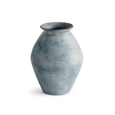 a blue vase sitting on top of a white table