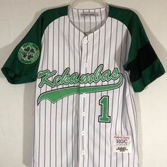 Introducing The Headgear Classic Men's Jersey G-Baby Hardball 2001! This Stylish And Comfortable Jersey Is Perfect For Both Casual Wear And Sports Activities. Featuring A Classic Striped Pattern In White And Green, Short Sleeves, And A Button Closure, It Is Made Of 100% Polyester Material That Is Machine Washable For Easy Care. The Size Of This Jersey Is S And It Is Suitable For Men's Regular Fit. It Is Also Great For Cycling As It Has Performance Activity Features. This Item Is New With Tags An White Cotton Jersey For Sports Fans, White Cotton Jersey For Game Day, White Cotton Fan Gear Jersey, White Cotton Baseball Jersey For Fans, Sporty White Baseball Jersey For Fans, White Cotton Jersey For College, White Cotton College Jersey, White Team Jersey For Streetwear, White Throwback Baseball Jersey For Sports Event