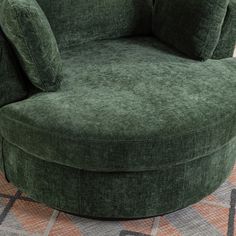 a large green chair sitting on top of a carpeted floor next to a rug