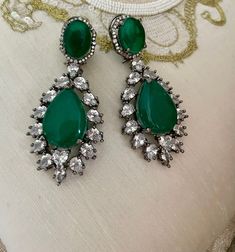 Emerald Green Diamond Earrings will be your perfect mate for the evening! Sparkle in this luxurious pair of Victorian earrings which are sure to make heads turn.  Details: Earrings Length-3 Inches Weight of Each Earring-23 grams All products are manufactured using traditional skills from our rich heritage of crafts.  The process of these crafts is essentially manual. Hence, any irregularities or variations are an inherent part of these handcrafting processes. Elegant Jeweled Green Earrings, Elegant Green Jeweled Earrings, Ornate Jeweled Party Earrings, Green Jeweled Chandelier Earrings For Wedding, Green Pierced Chandelier Earrings For Party, Green Chandelier Pierced Earrings For Party, Teardrop Hand Set Earrings For Party, Elegant Green Jeweled Bridal Earrings, Green Jeweled Crystal Earrings For Weddings