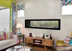 a living room filled with furniture and a flat screen tv mounted to the side of a wall