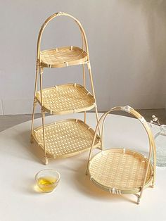 two wicker baskets sitting on top of a table next to a bowl and cup