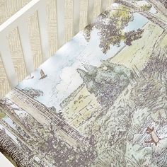 a baby crib with an image of a castle on the side and birds flying over it