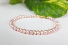 This delicate and elegant bracelet is made with pink tiny freshwater cultured pearls round shape, and it is finished with an Italian 925 silver clasp, plated gold. The pearls measure 0.5 mm approximately. The bracelet measures 18.5 cm, but I can make it longer by adding a gold chain. Feel free to contact me if you need more information or custom order! Pink Elegant Single Strand Beaded Bracelets, Elegant Pink Single Strand Beaded Bracelets, Pink Dainty Pearl Bracelet, Pink Pearl Bracelet With Pearl Drop, Delicate Pink Pearl Bracelet With Round Beads, Elegant Pink Pearl Bracelet With Round Beads, Delicate Pink Pearl Beaded Bracelet, Dainty Pink Pearl Bracelet With Pearl Charm, Pink Pearl Bracelet