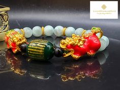 Gift yourself or your loveonce this beautiful bracelet. Crafted with 24 Karat Real Gold, Onyx, Agate and Angelite. Pixiu changes color. Metal: 24K Gold (Au999) Colour: Yellow Gold Gold Weight: Approximately 6.67grams Bracelet Width: Approximately 8mm Metal is Made of Real 24K Gold. Never Gold Filled. Never Gold Plated.  🧧Pixiu is a powerful Feng Shui symbol of wealth. It is believed that wearing the symbol of Pixiu brings money and good fortune to its wearer. This mythical creature is also thought to protect people from losing wealth. It also provides you not only physical protection, but also spiritual protection. 💥PLS FOLLOW US AND CHECK OUR OTHER LISTINGS. WE HAVE NEW STOCKS LISTED DAILY/WEEKLY.   OUR 24K GOLD IS MADE FROM 5G TECHNOLOGY What does 5G mean? 1, Grace : toughness, not eas Red Jade Bracelet As Gift, Red Jade Bracelet Gift, Spiritual Jade Bangle For Gift, Elegant Red Bracelets For Good Luck, Gold Jade Crystal Bracelet Gift, Elegant Green Bracelet For Good Luck, Spiritual Gold Bracelet With Round Beads As Gift, Handmade Gold Jade Crystal Bracelet, Luxury Red Bangle As A Gift