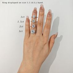 a woman's hand with three diamond rings on it