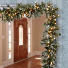 a mirror frame with christmas lights on it in the middle of a living room and hallway