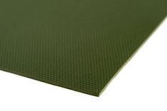 a close up view of a green mat on a white surface