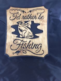 a wooden sign that says i'd rather be fishing with a fish on it