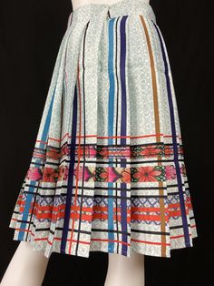 Mexican Fashion Pleated Skirt - Nayibi Mexico Talavera Skirt This elegant skirt is from the Talavera Collection inspired by the tiles of the region of Puebla where they began to make floors made of clay painted by hand taking as reference the Spanish pottery of which the Mexican appropriated this so-called “Talavera”. Lined Backed zipper *Pairs wonderfully with Talavera Top Care/Import Dry clean Import Contents 100% Polyester 100% Polyester Linning