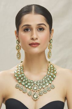 14kt gold plated green necklace made with semi-precious kundan stone embellishments. Comes with a matching pair of earrings. - Aza Fashions Gold-plated Green Kundan Necklace With Meenakari, Green Kundan Bridal Necklace Hand Set, Green Kundan Necklace With Meenakari In Gold Plated, Kundan Gemstone Necklace For Reception, Green Kundan Necklace With Meenakari Detail, Gold Emerald Chandbali Necklace, Green Gold Plated Kundan Necklace For Festivals, Green Gold-plated Kundan Necklace For Festivals, Green Gold Plated Bollywood Necklace