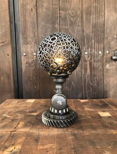 an old fashioned table lamp sitting on top of a wooden table