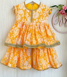 ✨ Looking for a stylish and comfortable outfit for your little girl? Consider the Yellow Floral Garara Set - a three-piece outfit that includes a top, garara pants, and a chunni. ✨ The Yellow Floral Garara Set is a beautifully designed outfit that is perfect for girls of all ages. The set includes a top, garara pants, and a chunni, all of which are made from high-quality fabric that is comfortable to wear and easy to care for. The outfit is completely lined, ensuring that your little one stays comfortable throughout the day. The main feature of this outfit is the stunning white floral print that covers the entire body of the garment. The print is vibrant and eye-catching, making this outfit perfect for a variety of occasions.  ✨ The top of the Kid Eid Dress features a simple yet elegant de Cotton Dress Pattern Indian Kids, Bandhej Dress For Kids, Bandini Dresses For Kids, Bandhani Dress Kids, Baby Pakistani Dress, Sari Dress For Kids, Patola Dress For Kids, Printed Garara, Garara Dress