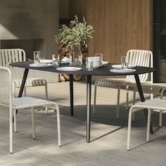 an outdoor table with four chairs around it