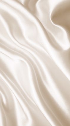 an image of white satin fabric textured with silky folds in the wind, closeup