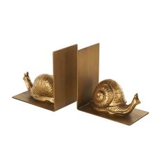 This snail set of 2 bookends is perfect for use in offices, or living rooms. This item ships in 1 carton. Iron bookends make a great gift for any occasion. Suitable for indoor use only. This item ships fully assembled in one piece. This gold colored iron non skid bookends comes as a set of 2. Farmhouse style. Red Barrel Studio® | Red Barrel Studio® Cole & Grey Metal Crawling Snail Decorative Bookends pink / yellowMetal in Gold | 6.1" H X 5.95" W X 3.55" D | Wayfair Decorative Bookends, Grey Metal, Book Ends, Lighting Sale, Game Room Furniture, Mudroom Furniture, Kitchen Dining Furniture, Outdoor Shade, Wall Display