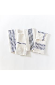 three white and blue towels folded on top of each other