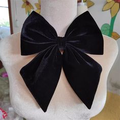 a white mannequin with a black bow on it