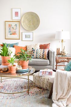 a living room filled with lots of furniture and plants on top of a coffee table