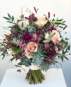 a bouquet of flowers sitting on top of a table