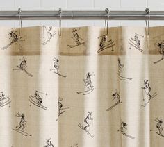 a shower curtain with drawings of skiers on it