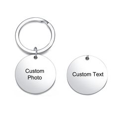 two metal key chains with the words custom text on them