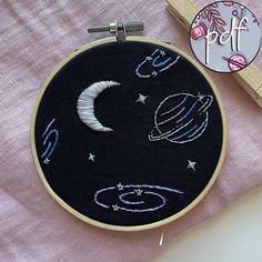 an embroidery project with space and stars on it