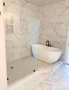 a bathroom with a tub, sink and shower stall in it's own area