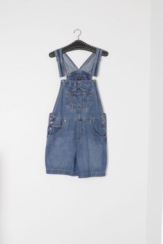 Cute, vintage denim short overalls. The brand is Route 66, well known makers of overalls. These vintage denim short overalls features a hammer loop on the back pocket. Shorten or length them with the adjustable clasp straps. The denim is medium weight and has a dark wash. The condition of these vintage denim short overalls is very good, with no marks to mention.   Marked size M.  Best fits up to size 12 Aus, US size 8 Measurements taken lying flat.-             Waist (doubled) -    88  cm/   35   inch             Hips  (doubled-     94  cm/    37  inch            Inseam-     11 cm/    4 inch            Thigh -  32 cm/    12.5 inch Cheap Denim Blue Cotton Shortalls, Vintage Denim Blue Cotton Shortalls, Vintage Bib Front Shortalls With Pockets, Retro Denim Bib Front Shortalls, Vintage Denim Shortalls With Bib Front, Vintage Denim Bib Front Shortalls, Vintage Medium Wash Shortalls For Spring, Retro Cotton Dark Wash Shortalls, Retro Style Shortalls With Pockets