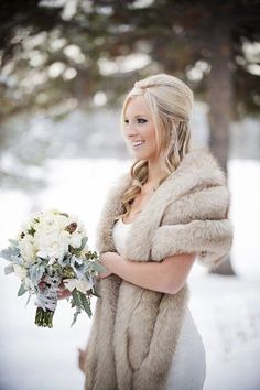 a woman in a fur coat holding a bouquet