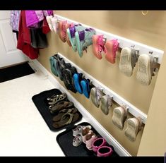 there are many pairs of shoes hanging on the wall