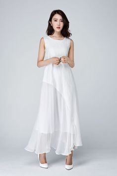 "The White dress is made with white linen, the below is white chiffon, inner has a white chiffon lining. The linen dress is loose, oversized. Layered linen dress from Xiaolizi. The maxi dress made from linen and chiffon fabrication in a relaxed-fit, shift silhouette. The summer dress features white lining that's topped with a round neck. Details: * Made of white 100% linen on the upper and white chiffon on the lower (light fabric) * Fully white chiffon lined, don't worry see through * The White White Sleeveless Dress For Spring Wedding, Flowy White Linen Dress For Spring, White Flowy Linen Dress For Spring, White Linen Sleeveless Dress For Beach, Elegant White Sleeveless Linen Dress, Elegant Sleeveless White Linen Dress, Elegant White A-line Linen Dress, White Chiffon A-line Maxi Dress, Elegant White Linen Maxi Dress