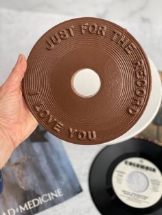 someone is holding up a chocolate cookie with the words just for the record on it