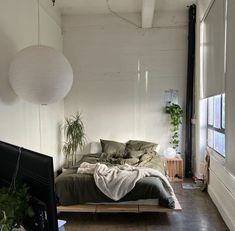 a bed sitting in the middle of a bedroom next to a window